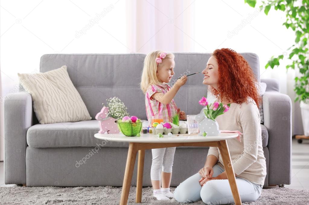 Mother and daughter decorating Easter eggs