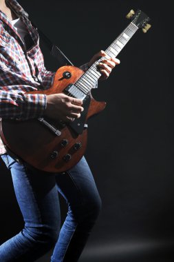 Young man playing electric guitar clipart