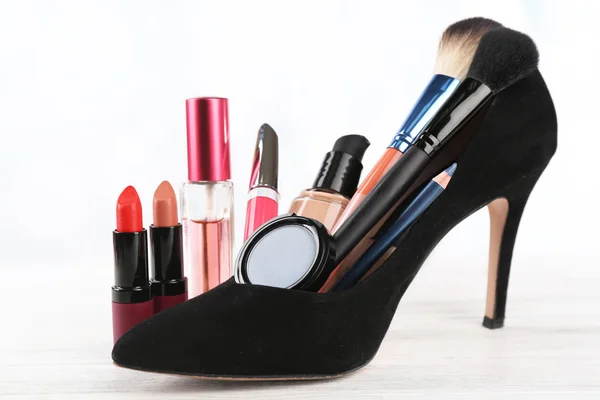 Set de maquillaje con zapato de mujer negro — Foto de Stock