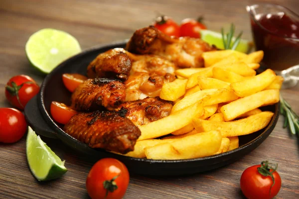 Asas de frango assadas com batatas fritas — Fotografia de Stock