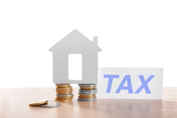 House figure, coins and tax sign — Stock Photo, Image