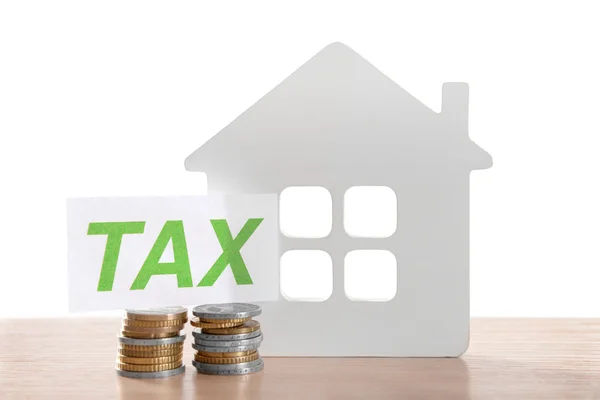 House figure, coins and tax sign — Stock Photo, Image