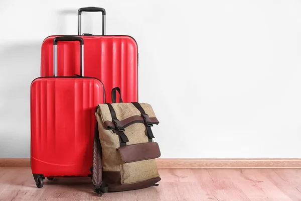 Different suitcases standing on floor — Stock Photo, Image