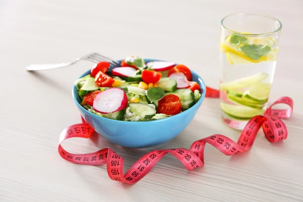 Fresh vegetarian salad and glass — Stock Photo, Image