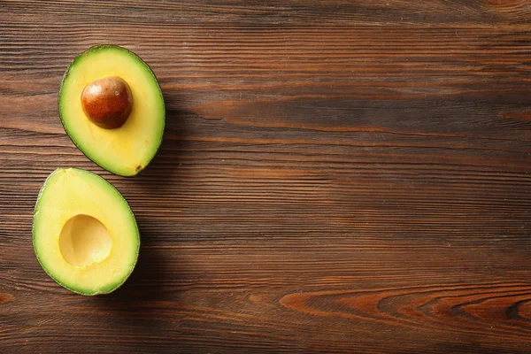 Avocado on wooden background — Stock Photo, Image