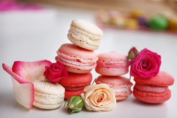 Macaroons with roses on white