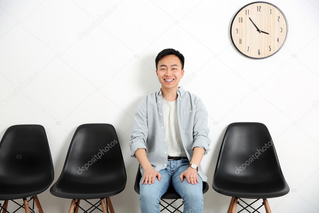 Young man waiting for interview indoors