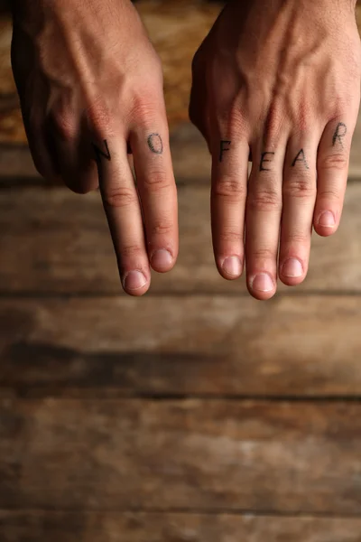Tattoo inscriptions on male fingers — Stock Photo, Image