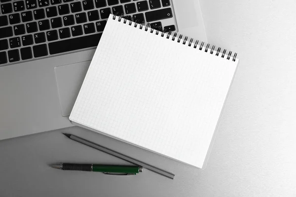 Empty  notebook on laptop keyboard — Stock Photo, Image