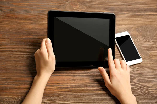 Teléfono móvil y manos femeninas usando tableta — Foto de Stock