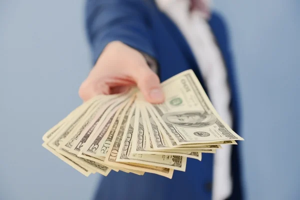 Attractive man holding fan of banknotes — Stock Photo, Image