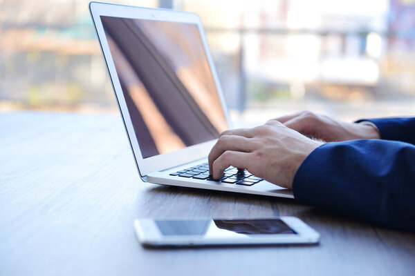 Man's hands using laptop