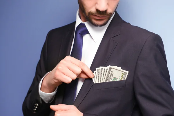 Attractive man getting dollar banknotes — Stock Photo, Image