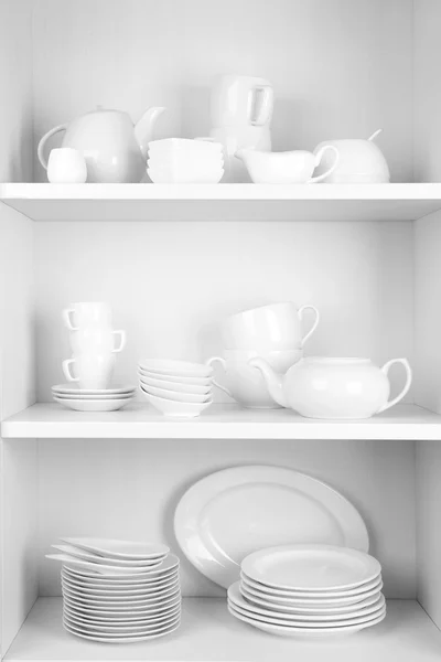 Dishes in cupboard in the kitchen — Stock Photo, Image