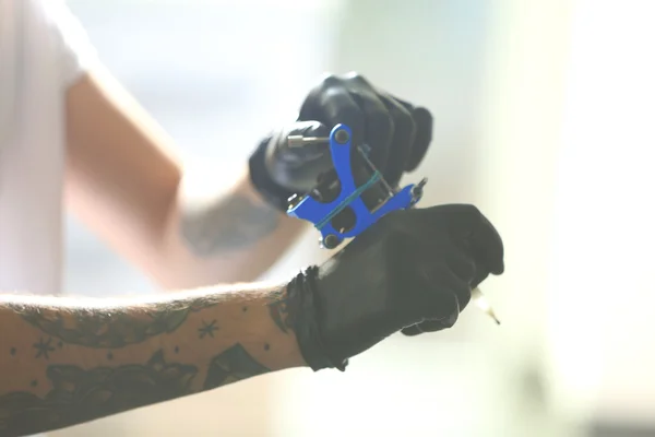 Ręce człowieka, trzymając Maszynka do tatuażu — Zdjęcie stockowe