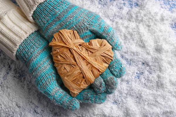 Hands in mittens with decorative heart — Stock Photo, Image