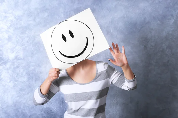 Woman showing a happy emoticon — Stock Photo, Image