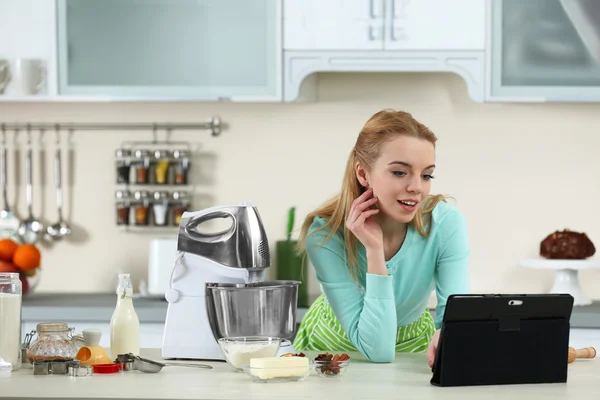 Woman using computer to follow a recipe