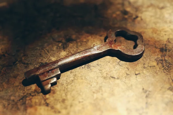 Old key on lighted background — Stock Photo, Image