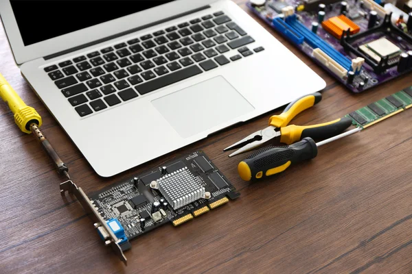 Laptop and Different electronic circuits — Stock Photo, Image