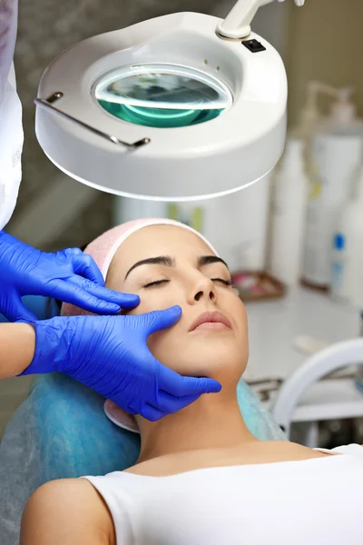 Young woman having face massage — Stock Photo, Image