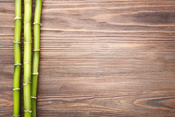 Bamboo branches on wooden — Stock Photo, Image