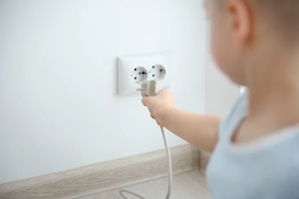 Boy playing with wire and plug — Stock Photo, Image