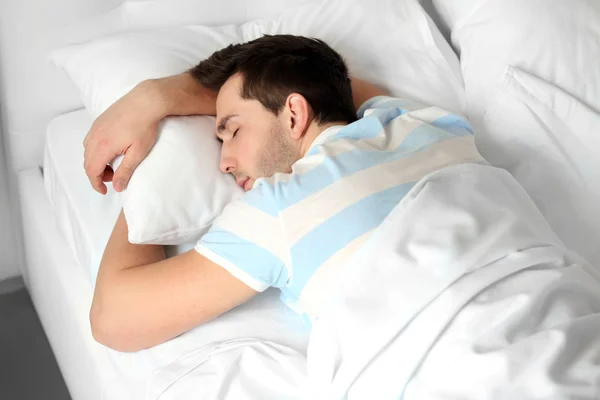 Young man sleeping in bed Royalty Free Stock Images