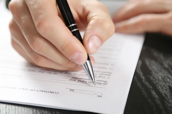 Male hand with pen signing document Royalty Free Stock Photos