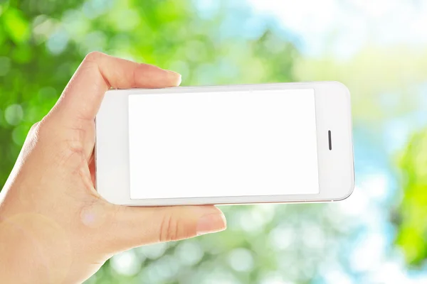 Hand shows mobile smart phone — Stock Photo, Image