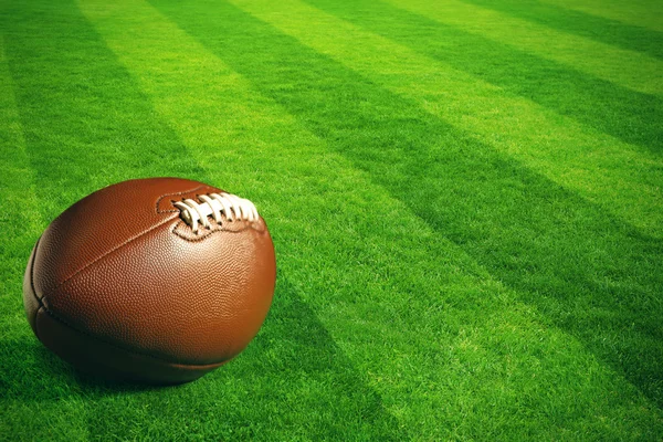 American football on green field — Stock Photo, Image