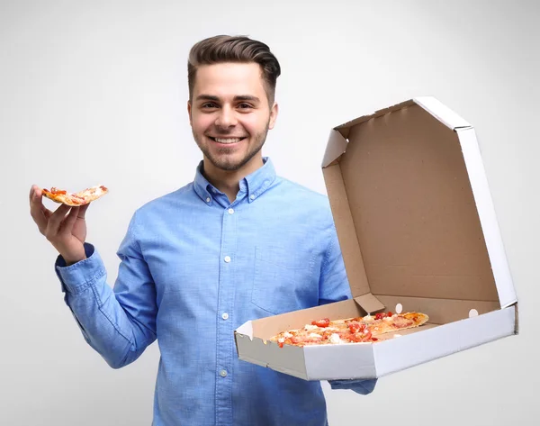 Młody przystojny mężczyzna z pizzą — Zdjęcie stockowe