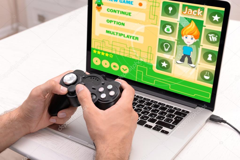 Young man playing computer games at home