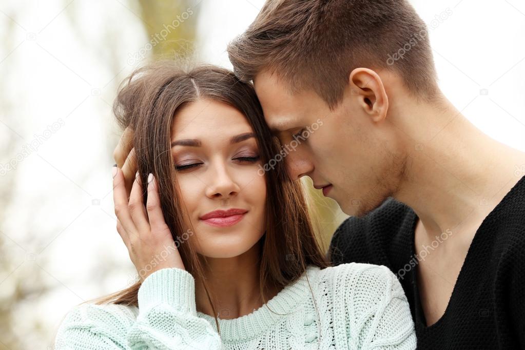 man touching hair of woman