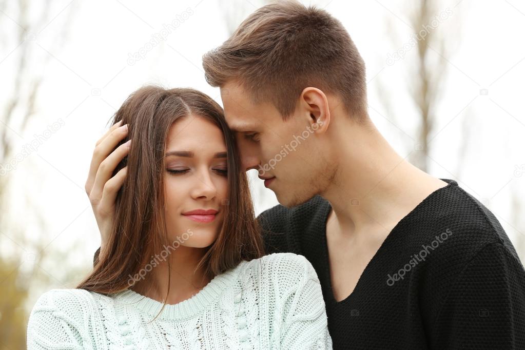 man touching hair of woman