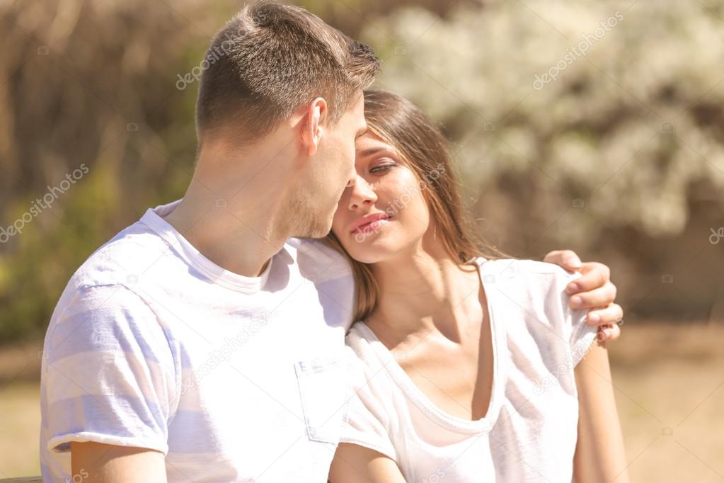 Young couple embracing outdoors in daylight