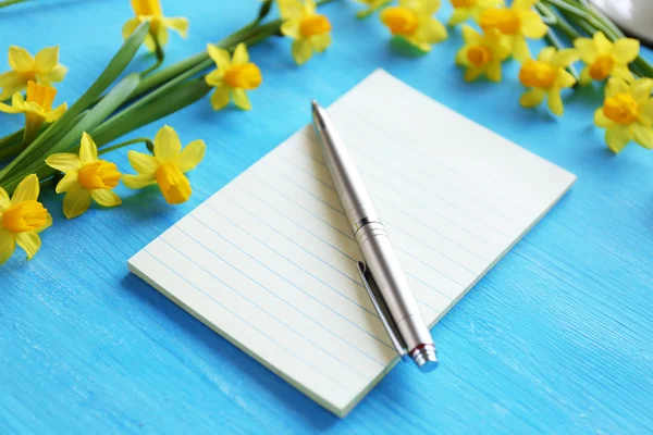 Notebook and daffodil flowers — Stock Photo, Image