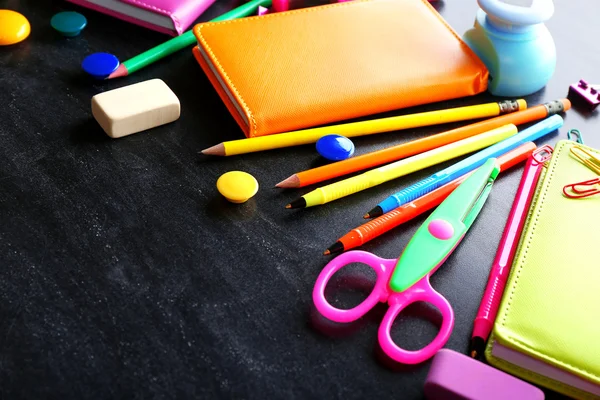 Colourful stationery on black — Stock Photo, Image