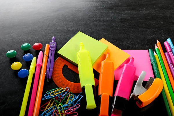 Colourful stationery on black — Stock Photo, Image