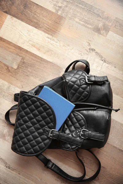 Leather backpack and book — Stock Photo, Image