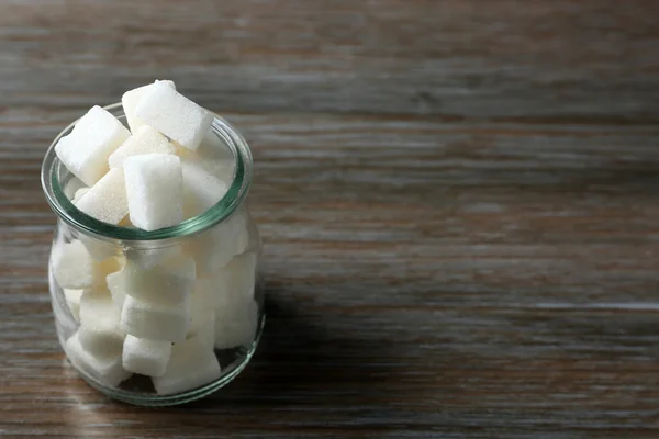 Glass jar with lump sugar — Stock Photo, Image