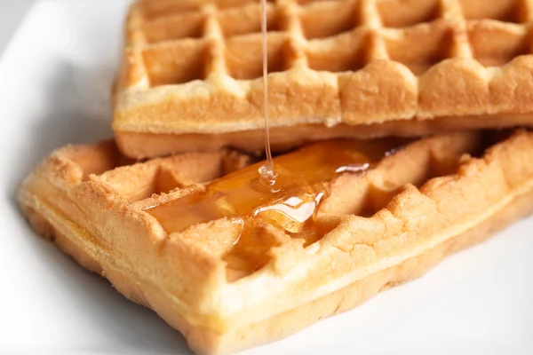 Tasty waffles with honey — Stock Photo, Image