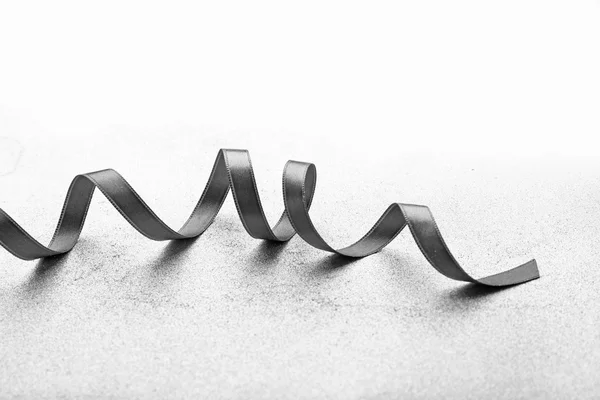 Grey ribbon on light — Stock Photo, Image