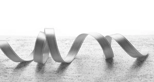 Grey ribbon on light — Stock Photo, Image