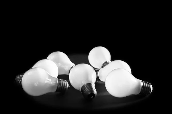 Electric bulbs on grey surface — Stock Photo, Image