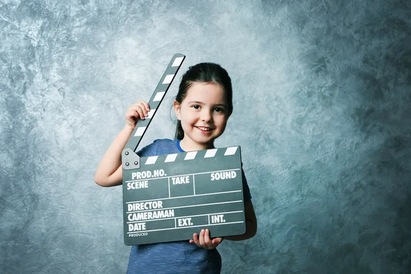 Little girl with clapperboard — Stock Photo, Image