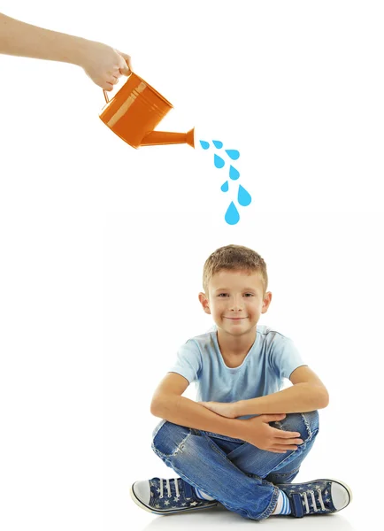 Hand with watering can pouring a boy — Stock Photo, Image