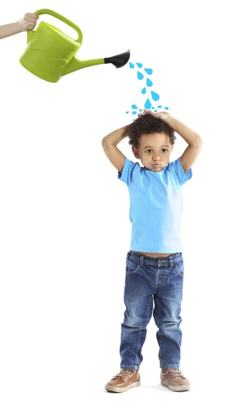 Hand with watering can pouring a boy — Stock Photo, Image