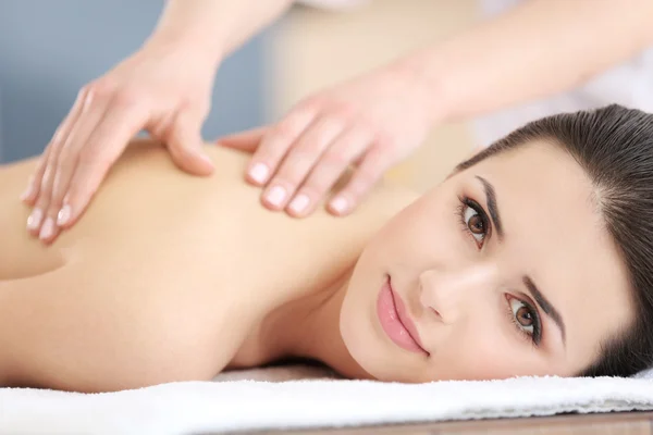 Jovem mulher fazendo massagem — Fotografia de Stock