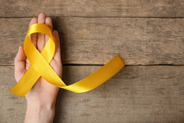 Yellow awareness ribbon — Stock Photo, Image